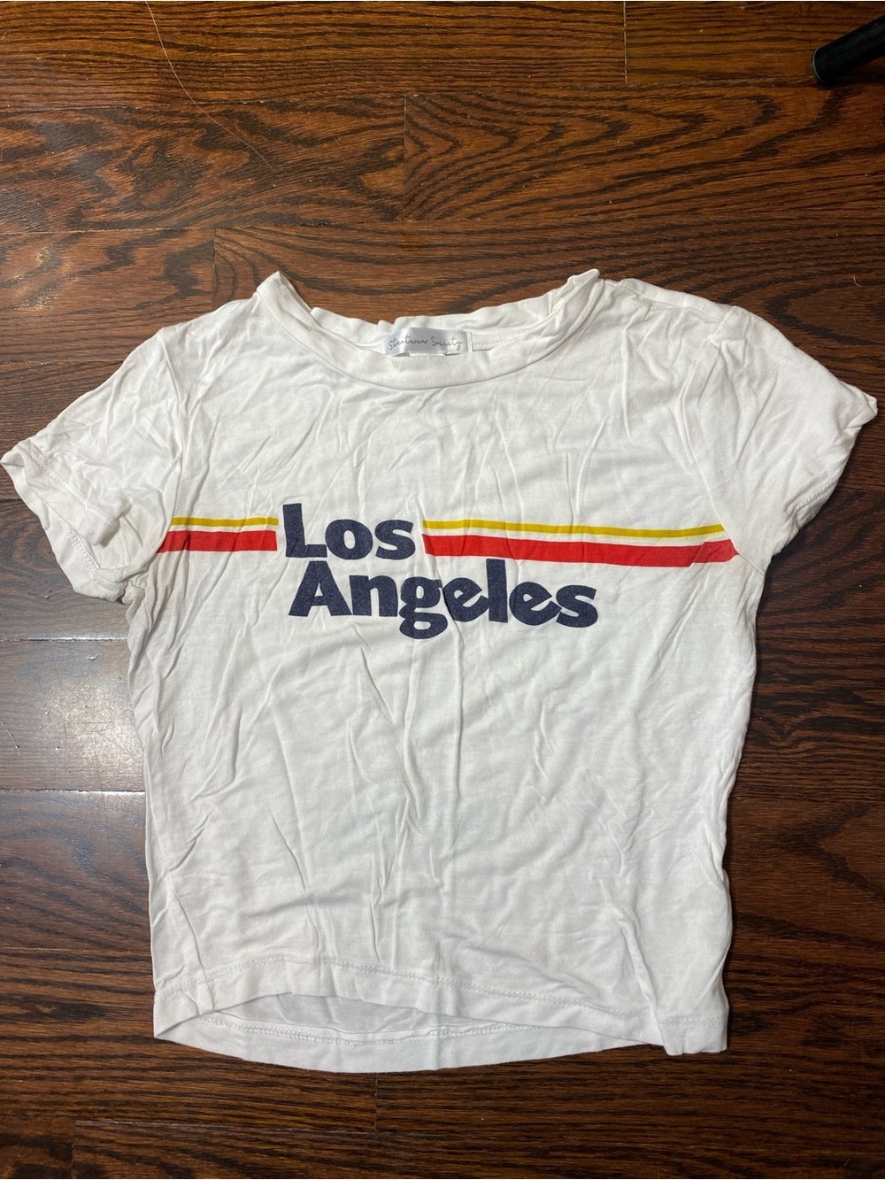 White graphic t-shirt featuring a rainbow stripe and "Los Angeles" text S